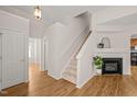 Bright living room with fireplace, staircase, and hardwood floors at 207 Bell Tower Way, Morrisville, NC 27560