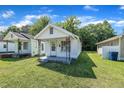 Cozy home with a covered front porch, green grass and shade trees at 215 N 4Th St, Smithfield, NC 27577