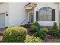 Charming front entrance with black shutters, brick steps, and manicured landscaping at 2240 Delaney Dr, Burlington, NC 27215