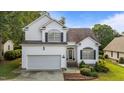 Charming home with a two-car garage, landscaped front yard, and classic architectural details at 2240 Delaney Dr, Burlington, NC 27215