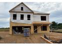 Exterior shot of a home under construction with visible framing and plywood at 241 E Victory View Ter, Smithfield, NC 27577