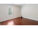 Cozy bedroom with hardwood floors and a large window providing natural light at 2523 Ferdinand Dr, Knightdale, NC 27545