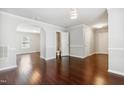 Spacious room with hardwood floors, decorative lighting, and a view of another room through an archway at 2523 Ferdinand Dr, Knightdale, NC 27545
