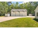 Spacious three-car garage with an additional storage area and a well-maintained lawn at 3010 Blueberry Ln, Chapel Hill, NC 27516