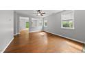 Open-concept living room with hardwood floors, abundant natural light, and neutral paint at 3033 Remington Oaks Cir, Cary, NC 27519
