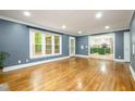 Bright living room with hardwood floors, views to the outside and a view to the modern kitchen at 309 Appaloosa Trl, Bahama, NC 27503