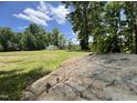 Large backyard featuring a shed and surrounded by beautiful trees at 318 Duck Pond Ln, Clayton, NC 27520