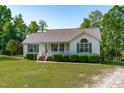 Attractive one-story home showcasing a well-manicured lawn and established landscaping at 318 Duck Pond Ln, Clayton, NC 27520