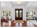 Bright foyer featuring gleaming hardwood floors and beautiful double doors at 3209 Bryant Falls Ct, Raleigh, NC 27613