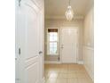 Inviting foyer featuring tile flooring, a decorative chandelier and a neutral color palette at 33 Juliette Dr, Durham, NC 27713