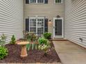 Cozy front entrance features a small seating area surrounded by well-maintained landscaping at 3339 Archdale Dr, Raleigh, NC 27614