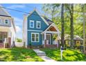 Charming two-story blue home features a welcoming front porch and well-maintained lawn at 407 1/2 Carolina Ave, Raleigh, NC 27606