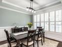 Formal dining room featuring a large window with plantation shutters and a stylish light fixture at 497 Rockport Dr, Clayton, NC 27527