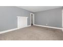 A bright bedroom with gray walls, white trim, gray carpet, and decorative mantel at 518 Avon Ave, Burlington, NC 27215