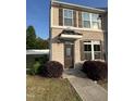 Charming brick front exterior featuring brown shutters and a covered entryway with the house number 523 at 523 Berry Chase Way, Cary, NC 27519