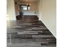 Open-concept living room with new dark-gray wood-look flooring and classic trim at 523 Berry Chase Way, Cary, NC 27519