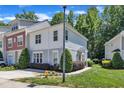 Attractive townhouse exterior with lush green landscaping, a well-maintained lawn, and clear blue skies at 534 Elm Ave, Wake Forest, NC 27587