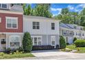 Charming townhouse with landscaped front yard and manicured bushes, featuring a neutral color scheme and inviting curb appeal at 534 Elm Ave, Wake Forest, NC 27587