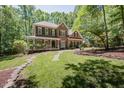 Charming brick home boasts a beautiful landscaped front yard and a welcoming porch at 5601 Jomali Dr, Durham, NC 27705