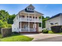 Charming two-story home boasts dual porches, stone accents, and mature landscaping at 5865 Forest Point Rd Rd, Raleigh, NC 27610