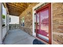 Cozy front porch with stone accents and a charming red front door at 5865 Forest Point Rd Rd, Raleigh, NC 27610