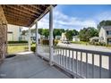 Spacious covered porch featuring classic white columns and a welcoming atmosphere at 5865 Forest Point Rd Rd, Raleigh, NC 27610