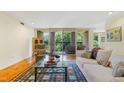 Inviting living room with a plush sofa, balcony access, and a beautifully patterned rug at 620 Martin Luther King Jr Blvd # Apt 502, Chapel Hill, NC 27514