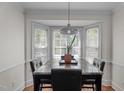 Bright dining area with bay window, granite-top table, and stylish lighting, creating the perfect space for Gathering meals at 6904 Sandringham Dr, Raleigh, NC 27613