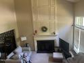 Bright living room featuring a fireplace with decorative molding and high ceilings at 713 Beddingfield Dr, Knightdale, NC 27545