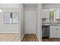Bright entryway featuring wood-look flooring, neutral walls, and a view into the kitchen at 7407 Sandy Creek Dr, Raleigh, NC 27615