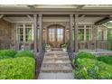 Inviting front entrance with a stone pathway, decorative plants, and a stylish double-door entry at 7544 Hasentree Club Dr, Wake Forest, NC 27587