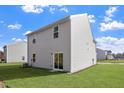 Spacious backyard with lush green grass, sliding glass door, and ample space for outdoor activities at 815 Rhino Bnd, Oxford, NC 27565