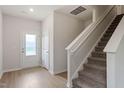 Inviting entryway featuring wood-look floors, a stairway, and natural light from the front door at 815 Rhino Bnd, Oxford, NC 27565