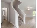 Carpeted stairs leading to the upper level, complemented by modern wood-look floors at 815 Rhino Bnd, Oxford, NC 27565