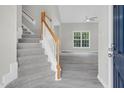 Bright open floor plan with gray vinyl flooring and a staircase leading to the upper level at 8820 Waynick Dr, Raleigh, NC 27617