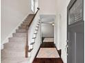 Inviting entryway with hardwood floors, staircase, and view into the living area at 904 Palm Ct, Mebane, NC 27302