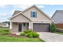 Charming home with a two-car garage, well-maintained lawn, and attractive landscaping at 904 Palm Ct, Mebane, NC 27302