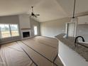 Spacious living room boasts vaulted ceilings, modern fireplace, and seamless flow to the kitchen, perfect for entertaining at 94 Royal Ave, Selma, NC 27576