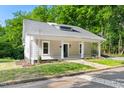 Charming home featuring a covered porch with white columns and a landscaped front yard at 1010 Cobb St, Durham, NC 27707
