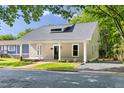 Charming home featuring a covered porch with white columns and a landscaped front yard at 1010 Cobb St, Durham, NC 27707