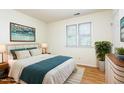 Cozy bedroom with natural light, a comfortable bed, and hardwood floors at 1015 Boathouse Ct, Raleigh, NC 27615