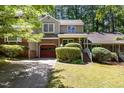 Inviting home with a brick and siding facade, a red garage door, and well-maintained landscaping at 1015 Boathouse Ct, Raleigh, NC 27615