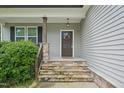 Inviting front porch with stone steps and decorative wreath on front door at 10504 Carsons Creek Dr, Zebulon, NC 27597