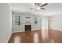 Bright living room featuring a fireplace, hardwood floors and ample natural light at 10504 Carsons Creek Dr, Zebulon, NC 27597