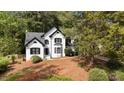 Traditional home with white brick, black trim, and beautiful front yard at 106 Windstream Way, Cary, NC 27518