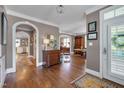Elegant foyer with hardwood floors, arched doorways, and classic decor at 10608 Thornbury Crest Ct Ct, Raleigh, NC 27614