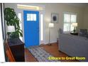 Bright entryway featuring hardwood floors, a vibrant blue front door, and stylish decor at 107 Norwood Dr, Clayton, NC 27527