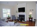 Inviting living room featuring a fireplace, plush seating, and ample natural light at 107 Norwood Dr, Clayton, NC 27527