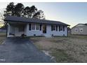 Cozy single-story home with a convenient carport and a paved driveway at 109 Pine St, Dunn, NC 28334