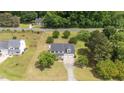 Beautiful home with mature trees on a large lot, featuring a long driveway and well-maintained landscaping at 114 Lynnville Ct, Lillington, NC 27546